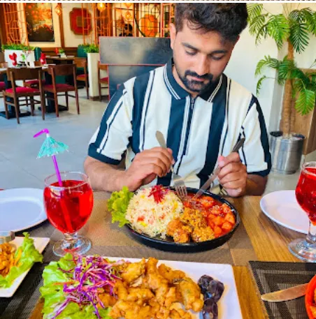 A guest eating at Yin & Yummy